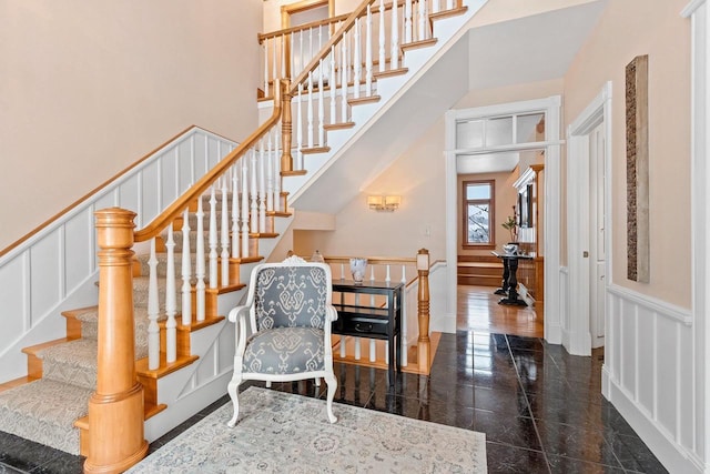 2532 Huntington Way, Suamico, WI 54173 - interior space with granite finish floor, a decorative wall, a towering ceiling, and wainscoting