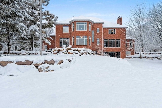 2532 Huntington Way, Suamico, WI 54173 - snow covered back of property with brick siding and a chimney
