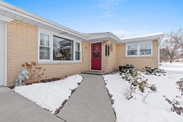 view of snow covered property entrance