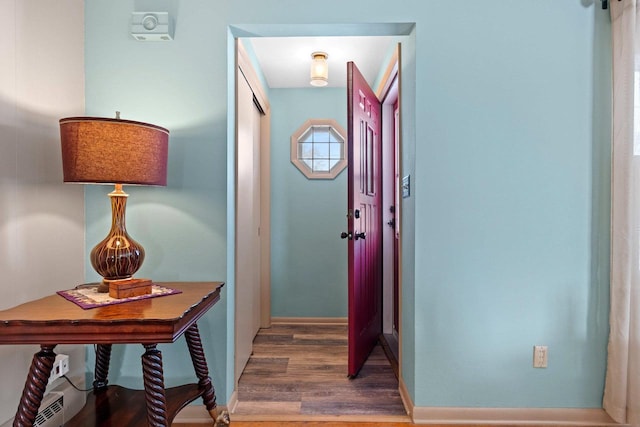 hallway with hardwood / wood-style flooring