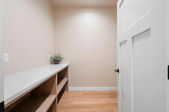 hallway with light hardwood / wood-style floors