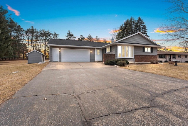 view of front of home featuring a garage and a lawn