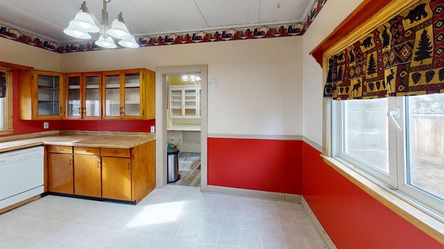 kitchen with an inviting chandelier, hanging light fixtures, and dishwasher