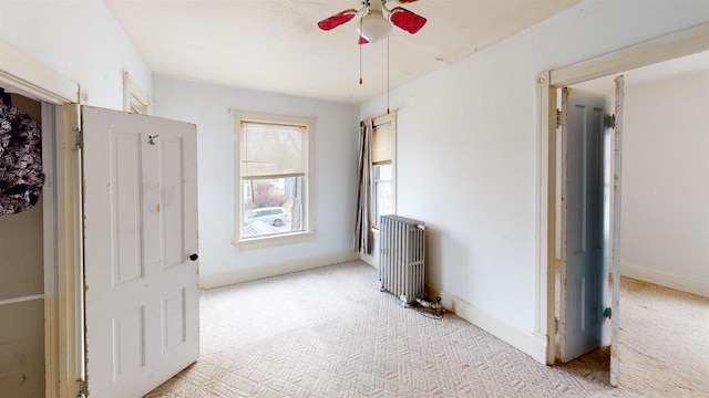 interior space with radiator and light colored carpet