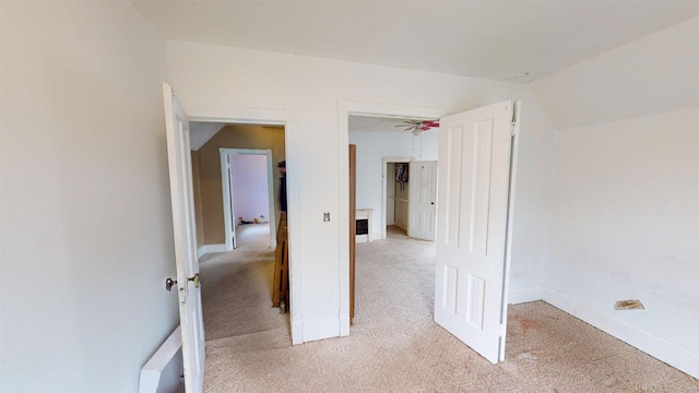 interior space featuring lofted ceiling and light colored carpet