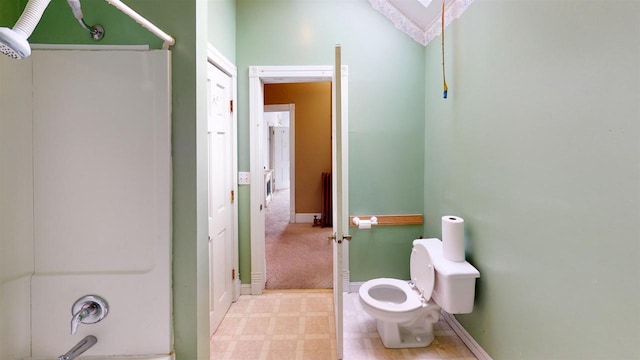 bathroom with vaulted ceiling, bathtub / shower combination, and toilet