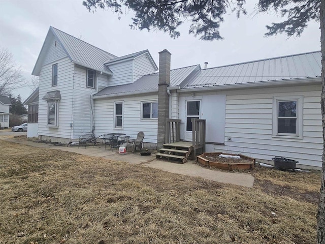 back of property featuring a yard and a patio area