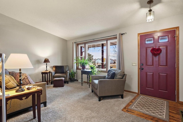 entrance foyer featuring carpet flooring and a textured ceiling