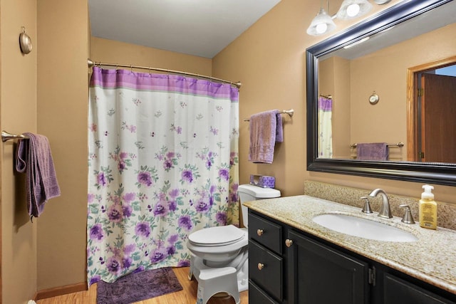 bathroom featuring hardwood / wood-style floors, vanity, curtained shower, and toilet