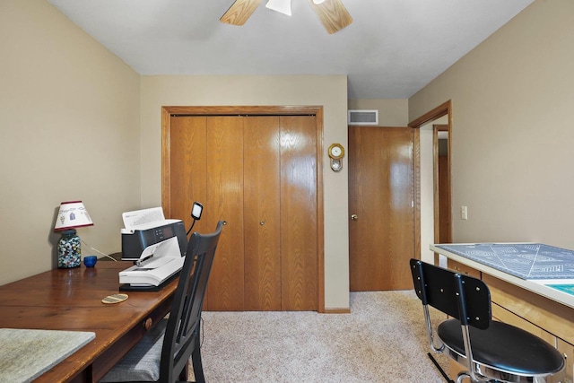 carpeted home office with ceiling fan