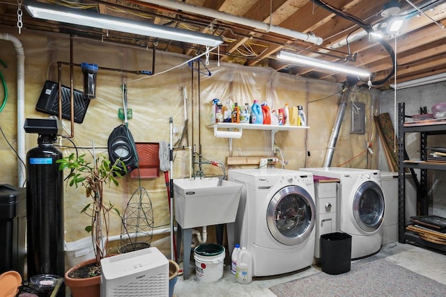 laundry room with washer and dryer, sink, and electric panel