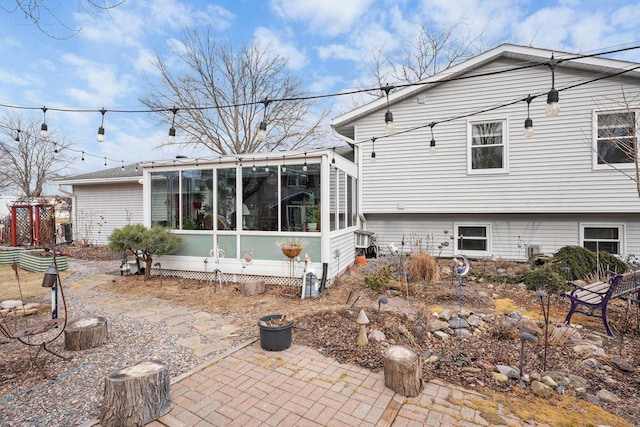 rear view of property with a sunroom