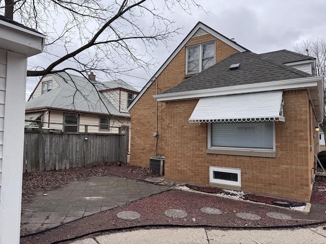 back of house with central AC unit and a patio area