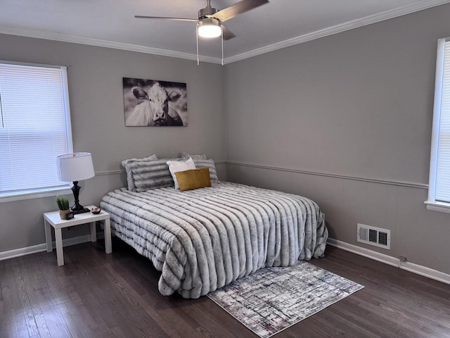 bedroom with crown molding, dark wood-type flooring, and ceiling fan