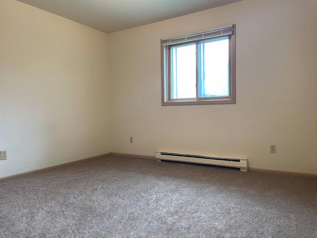 empty room with a baseboard radiator and carpet