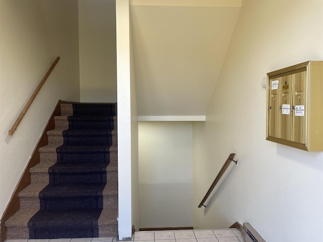 stairs with tile patterned flooring and a baseboard heating unit