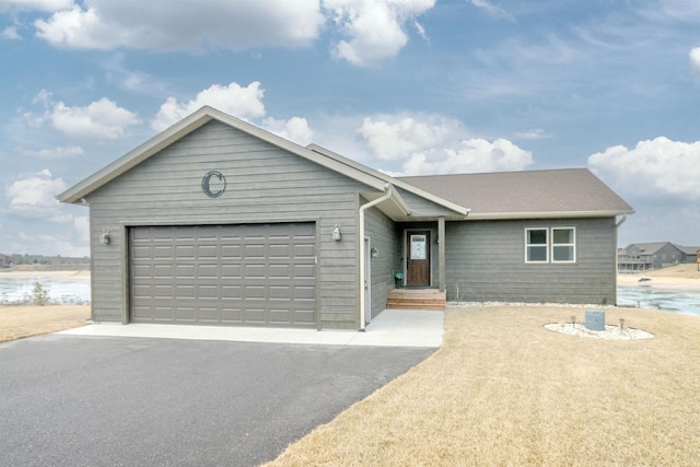 ranch-style home with a water view and a garage