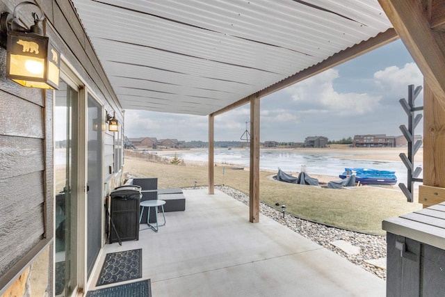 view of patio with a water view