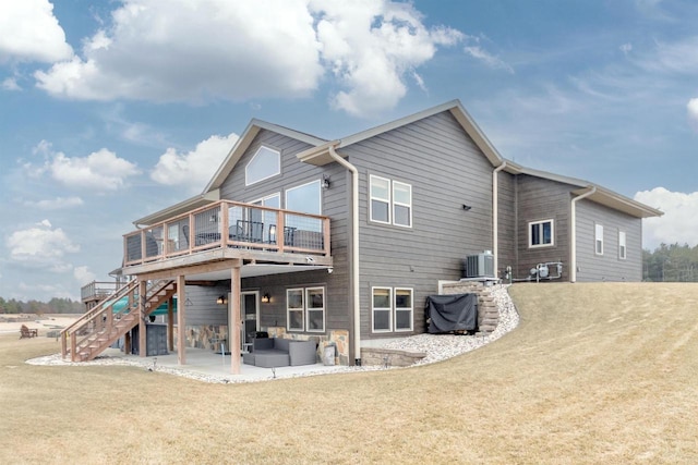 rear view of property featuring a patio, a yard, cooling unit, and a wooden deck