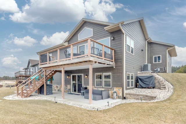 back of property with central AC, an outdoor hangout area, a patio area, and a lawn