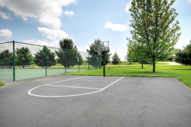 view of sport court featuring a lawn