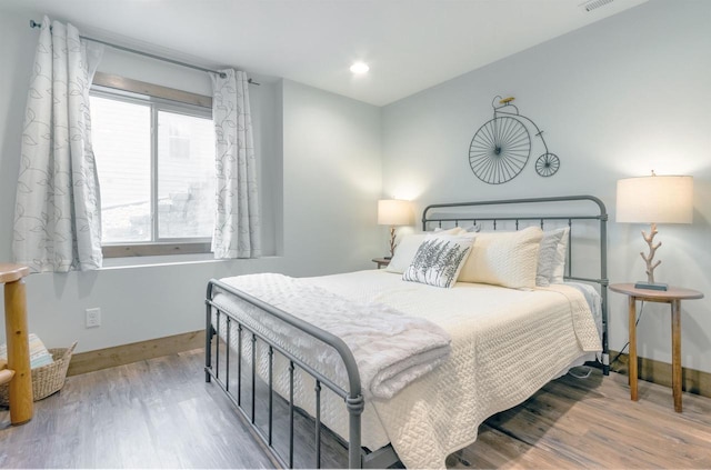 bedroom with hardwood / wood-style flooring