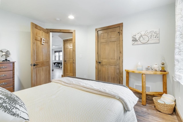 bedroom with wood-type flooring