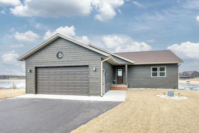 single story home featuring a water view and a garage