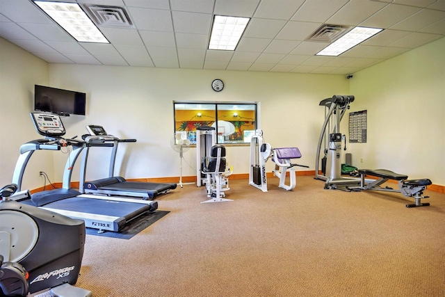 workout room with a paneled ceiling