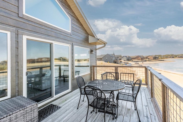 wooden terrace featuring a water view