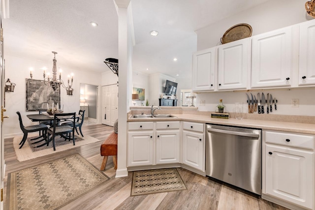 kitchen featuring white cabinetry, dishwasher, and sink