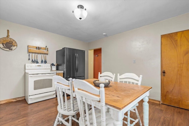 dining space with dark hardwood / wood-style floors