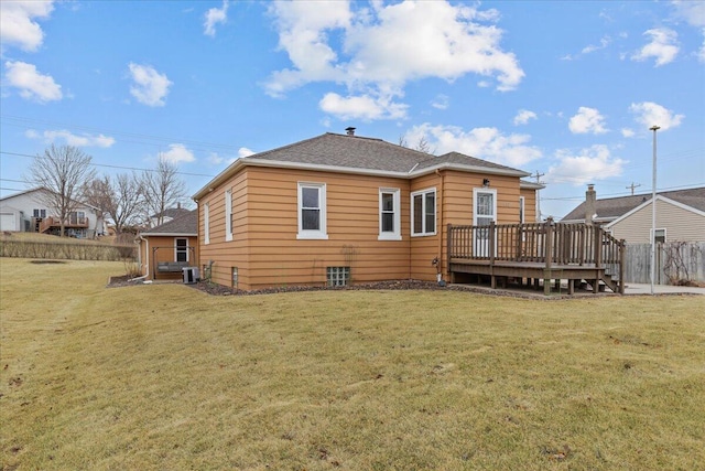 rear view of house featuring a wooden deck, a lawn, and central air condition unit