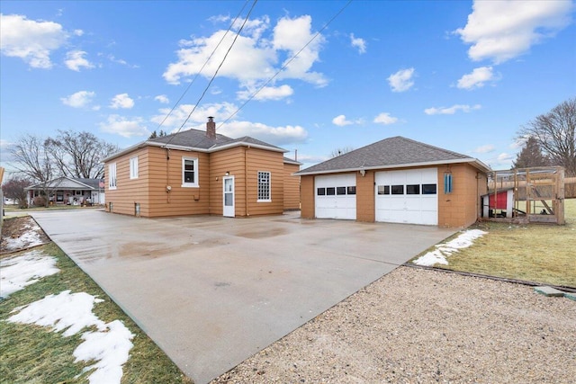 exterior space with a garage and an outdoor structure