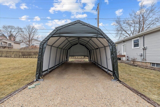 view of parking / parking lot with a lawn and a carport