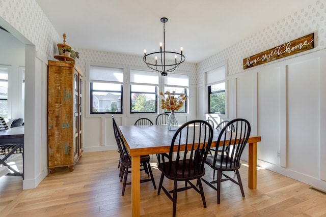 dining room featuring an inviting chandelier and light wood-type flooring