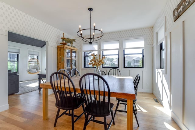 dining area with an inviting chandelier and light wood-type flooring