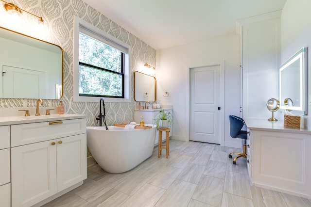 bathroom with vanity and a tub to relax in