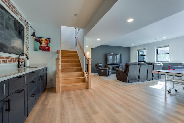 living room featuring sink and light hardwood / wood-style floors