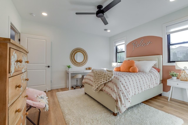 bedroom with light hardwood / wood-style flooring and ceiling fan