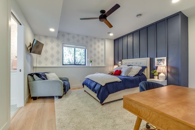 bedroom with ceiling fan and light hardwood / wood-style floors