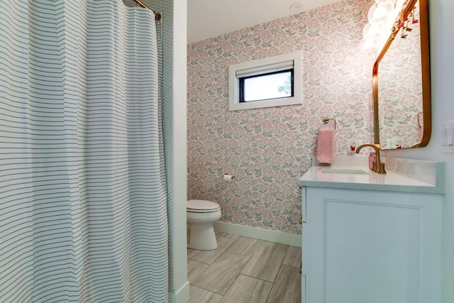 bathroom featuring vanity, toilet, and a shower with shower curtain