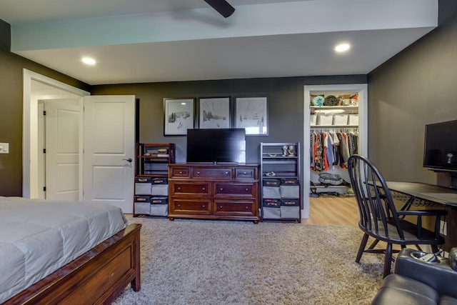 bedroom with a spacious closet, ceiling fan, and a closet