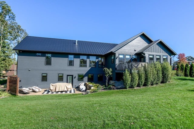 rear view of property featuring a patio and a lawn