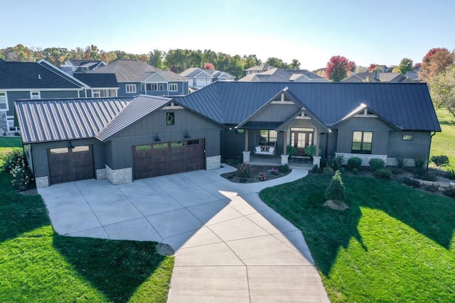 modern inspired farmhouse with a garage and a front lawn