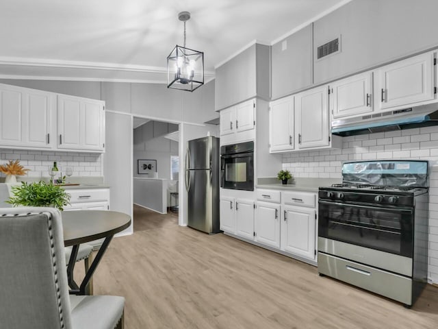 kitchen featuring stainless steel refrigerator, white cabinetry, oven, hanging light fixtures, and gas range