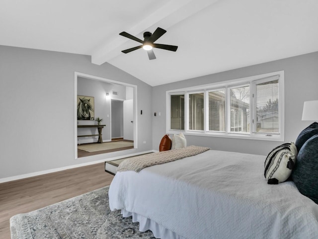 bedroom featuring vaulted ceiling with beams, hardwood / wood-style flooring, and ceiling fan