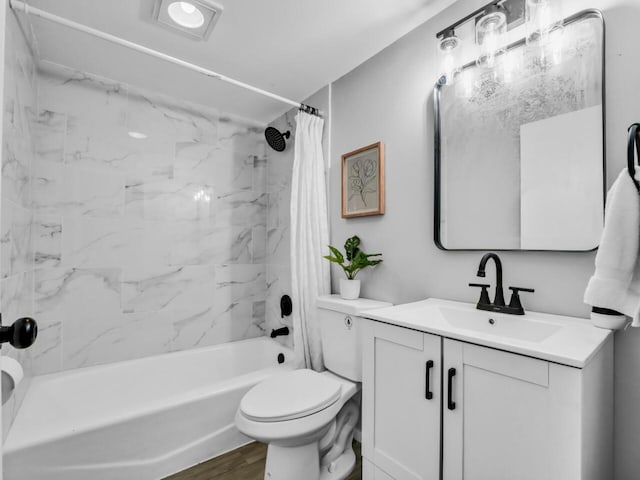 full bathroom featuring vanity, shower / tub combo, hardwood / wood-style flooring, and toilet