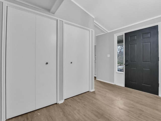 entrance foyer with lofted ceiling and light wood-type flooring