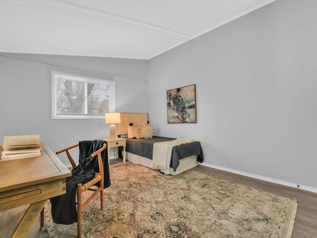 bedroom with wood-type flooring and lofted ceiling